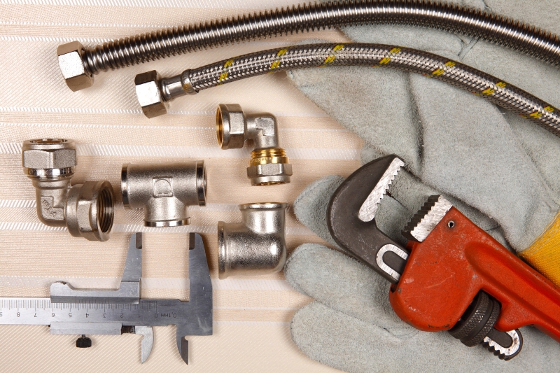 Plumber working on pipes in a Chiswick home